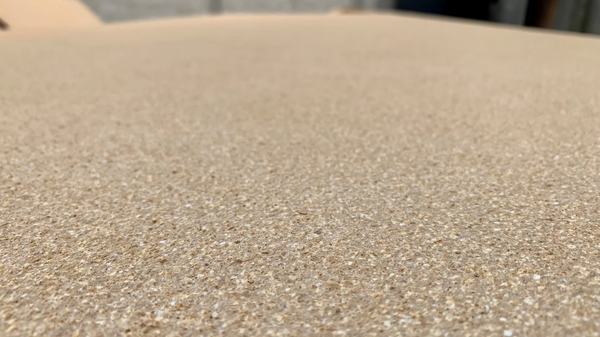 Detail of the sand-colored surface finish